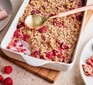 A baking dish of baked oatmeal with raspberries