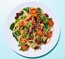 A plate of spaghetti with kidney beans, spinach, tomatoes and olives