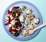 A plate of beetroot and apple salad served with meatballs and a creamy sauce