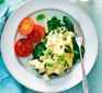 Scrambled eggs with basil, spinach & tomatoes on a plate