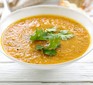 Carrot soup with coriander in bowl
