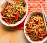 Curried satay noodles in two bowls