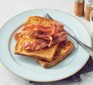 Eggy bread with bacon on plate