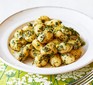 Gnocchi with herb sauce served on a white plate