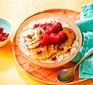 Bowl of porridge topped with fresh fruit