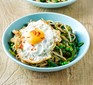 A bowl of wholemeal noodles with vegetables and fried eggs
