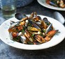 Mussels with chorizo, beans & cavolo nero served in a bowl