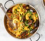 Paella with prawns and mussels served in a pan