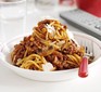 Spaghetti bolognese in a white bowl with parmesan