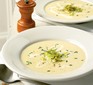Leek & potato soup garnished with chives, buttered leeks & cream