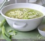 Healthy courgette, potato & cheddar soup in a white bowl topped with cheese