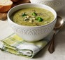 Broccoli and stilton soup in a patterned bowl with napkin & spoon