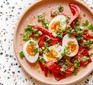 Roast peppers with ‘jammy’ eggs & almond & parsley dressing served on a plate