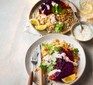 Two servings of roasted harissa red cabbage with coriander & almond bulgur