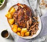 Slow cooker lamb shoulder served with roast potatoes