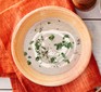 Mushroom soup in bowl with herbs and cream