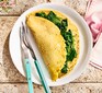 Vegan chickpea flour omelette filled with spinach on a white plate