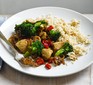 Stir-fried chicken with broccoli & brown rice on a white plate
