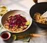 A serving of tahini noodles with red cabbage & Sichuan peppercorn slaw