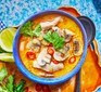 Thai-inspired coconut chicken soup served in a decorative blue bowl
